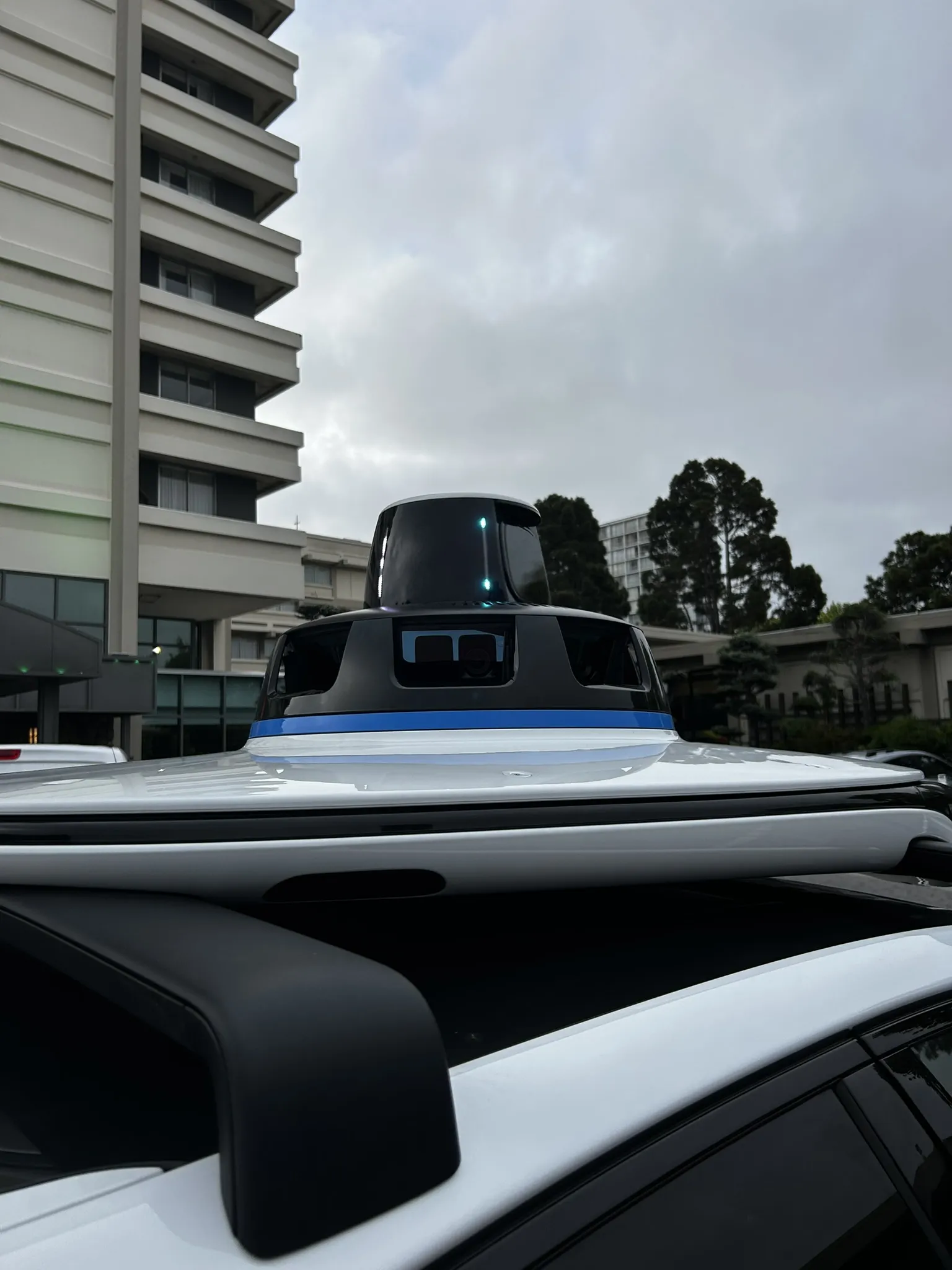 Close-up of the Waymo sensor dome on the roof of the Jaguar I-PACE