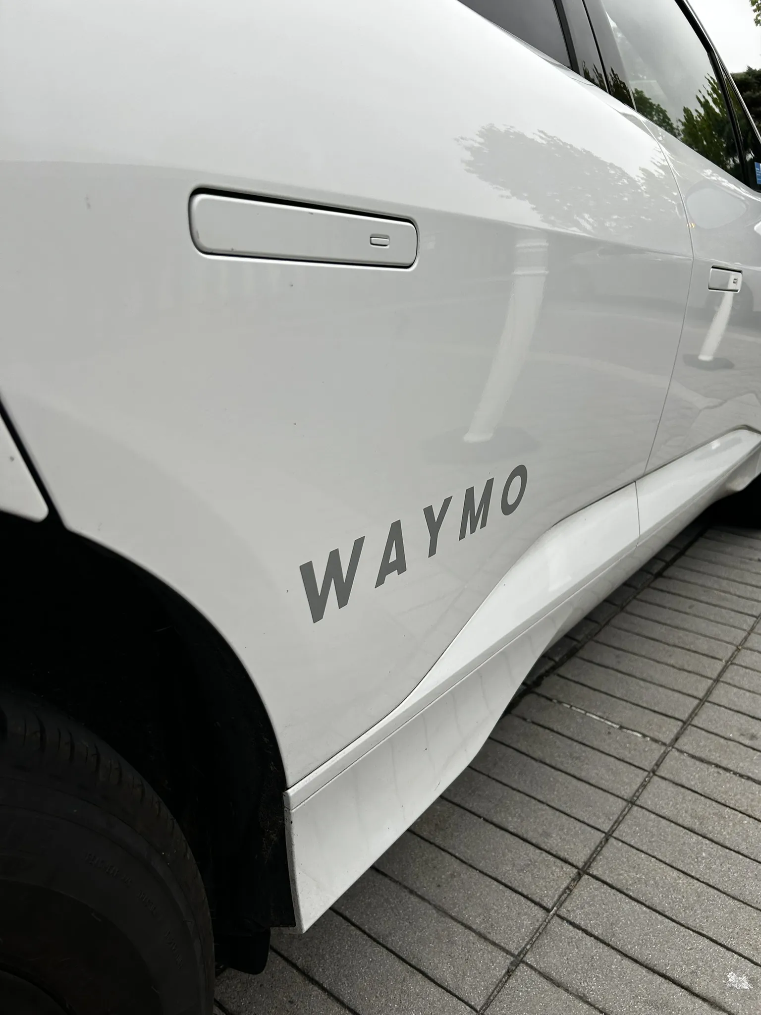 WAYMO branding on the side of the Jaguar I-PACE